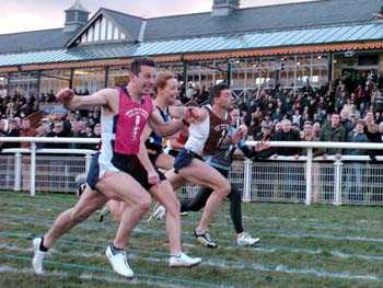 George Charlton (pink bib) winning New Year Sprint from Gary Wilson (purple bib) and Karen Cochrane (dark blue bib).