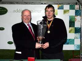 Provost Pat O'Brien presents the trophy to 2006 New Year Sprint winner Cumbie Bowers.
